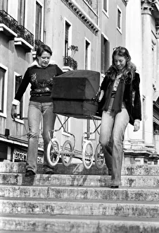 People: Culture: General scenes in Venice. A couple of young women carry a pram over one People: Culture: General scenes in Venice. A couple of young women carry a pram over one