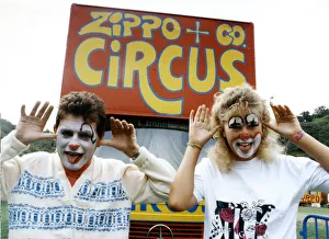 Two people with their faces painted like clowns, pulling funny faces, at the Zippo & Co Two people with their faces painted like clowns, pulling funny faces, at the Zippo & Co