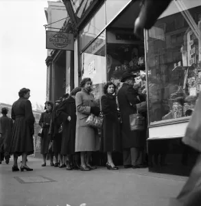 People queuing up outside a confectioney shop after sweets came off the ration following People queuing up outside a confectioney shop after sweets came off the ration following