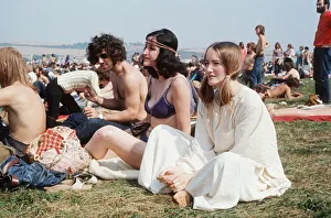 People sitting on grass at Isle of Wight Festival Hippies flower power People sitting on grass at Isle of Wight Festival Hippies flower power