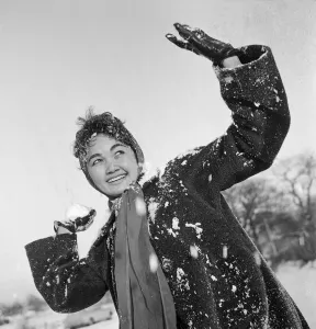 Philippine dancers have a snowball fight in London. One of the woman throwing Philippine dancers have a snowball fight in London. One of the woman throwing