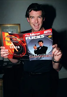 Pierce Brosnan 007 star with a copy of the December 1997 Mirror Flicks Magazine Pierce Brosnan 007 star with a copy of the December 1997 Mirror Flicks Magazine