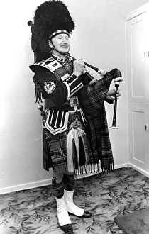 A piper smarly dressed in his uniforn and ready to play the bagpipes in March 1982 A piper smarly dressed in his uniforn and ready to play the bagpipes in March 1982