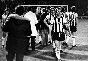 Players and officials gather round Mick Mahoney after Newcastle' Players and officials gather round Mick Mahoney after Newcastle'