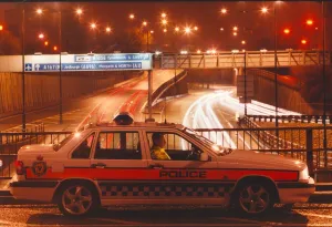 A police officer watches the traffic whizz by in his patrol car 01/06/95 circa A police officer watches the traffic whizz by in his patrol car 01/06/95 circa