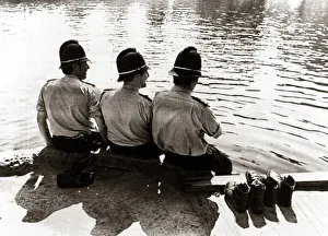 policemen sitting by a river on a hot sunny day... July 1976 summer sun policemen sitting by a river on a hot sunny day... July 1976 summer sun