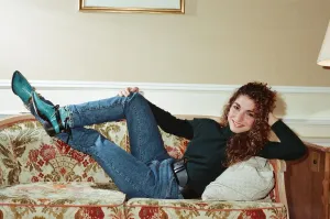 Pop singer Gloria Estefan poses lying down on a sofa in her hotel room on a visit to Pop singer Gloria Estefan poses lying down on a sofa in her hotel room on a visit to
