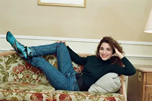 Pop singer Gloria Estefan poses lying down on a sofa in her hotel room on a visit to Pop singer Gloria Estefan poses lying down on a sofa in her hotel room on a visit to