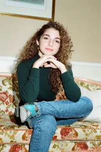 Pop singer Gloria Estefan poses sitting down on a sofa in her hotel room on a visit to Pop singer Gloria Estefan poses sitting down on a sofa in her hotel room on a visit to