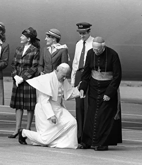 Pope John Paul II at Cardiff airport on his visit to Wales kneels down to kiss the ground Pope John Paul II at Cardiff airport on his visit to Wales kneels down to kiss the ground