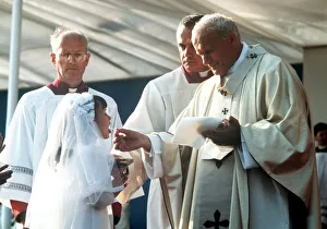 Pope John Paul II giving Holy Communion at Bellahouston Park in Glasgow, Scotland Pope John Paul II giving Holy Communion at Bellahouston Park in Glasgow, Scotland