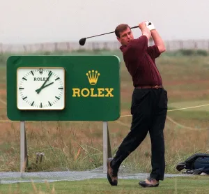 Prince Andrew playing golf at Royal Troon, July 1997 Rolex logo clock in background Prince Andrew playing golf at Royal Troon, July 1997 Rolex logo clock in background