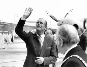 Prince Philip, Duke of Edinburgh waves to a party of happy school children who were Prince Philip, Duke of Edinburgh waves to a party of happy school children who were