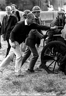 Prince Philip helping to push a carriage. Windsor horse show. May 1987 Prince Philip helping to push a carriage. Windsor horse show. May 1987