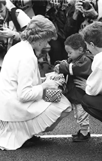Princess Diana handing out a few surprise gifts to children at the start of the 1988 Princess Diana handing out a few surprise gifts to children at the start of the 1988