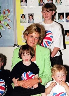 Images Dated 30th June 1996: Princess Diana sitting with Caitlin Hines on her lap during a visit to a children