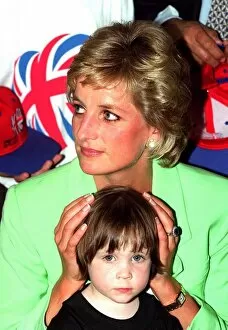 Images Dated 30th June 1996: Princess Diana sitting with Caitlin Hines on her lap during a visit to a children