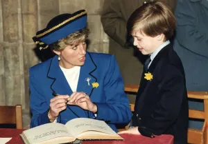 Princess Diana with her son Prince William signing their names in the visitors book of Princess Diana with her son Prince William signing their names in the visitors book of
