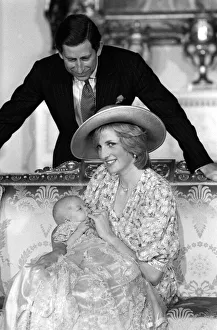 Princess Diana, watched by husband prince Charles, holds her son Prince William in her Princess Diana, watched by husband prince Charles, holds her son Prince William in her