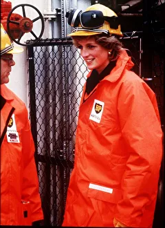 Princess Diana wearing a construction hard hat with protective ear guards Princess Diana wearing a construction hard hat with protective ear guards