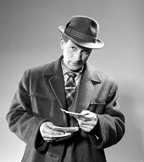 A punter holding his betting slips before placing his bet March 1963 A punter holding his betting slips before placing his bet March 1963