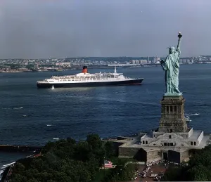 The QE2 Ship leaves New York Harbour past the Statue of Liberty April 1992 The QE2 Ship leaves New York Harbour past the Statue of Liberty April 1992