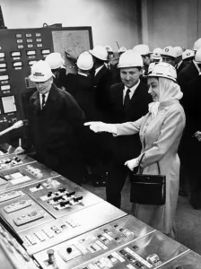 Queen Elizabeth II wearing protective clothing, watches the control panel of the new Queen Elizabeth II wearing protective clothing, watches the control panel of the new