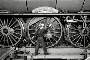 Images Dated 24th June 1987: Railway worker shows the scale of the wheels on the Flying Scotsman steam train