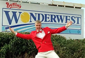 Redcoat Aidan welcomes visitors to Butlins Worderwest World Wonderwest World sign in Redcoat Aidan welcomes visitors to Butlins Worderwest World Wonderwest World sign in