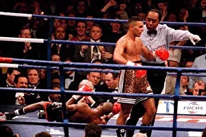 The referee leads Prince Naseem Hamed to his corner after knocking Tom Boom Boom Johnson The referee leads Prince Naseem Hamed to his corner after knocking Tom Boom Boom Johnson