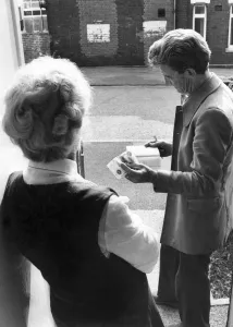 Rent collector collecting weekly rent from a tenant. September 1975 P005425 Rent collector collecting weekly rent from a tenant. September 1975 P005425