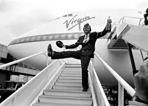 Richard Branson drinking from a bottle of champagne as he celebrates Virgin Atlantic Richard Branson drinking from a bottle of champagne as he celebrates Virgin Atlantic