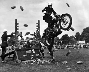 A rider of Royal Corps of Signals cycle display team crashes through a wall of bricks at A rider of Royal Corps of Signals cycle display team crashes through a wall of bricks at
