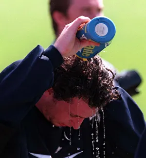 Robbie Fowler pours water over his head to cool off during a Liverpool training session Robbie Fowler pours water over his head to cool off during a Liverpool training session