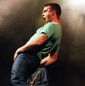 Robbie Williams in concert at slane castle August 1999 Gyrating to the fans Robbie Williams in concert at slane castle August 1999 Gyrating to the fans