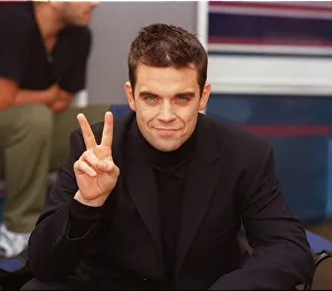 Robbie Williams relaxes on the set of his lastest video being shot in the grounds of Robbie Williams relaxes on the set of his lastest video being shot in the grounds of
