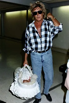Rod Stewart Singer With baby daughter leaving Heathrow Rod Stewart Singer With baby daughter leaving Heathrow