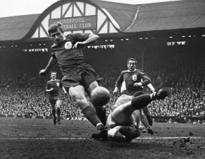 Roger Hunt in action for Liverpool at Anfield, watched by teammate Ian St John during a Roger Hunt in action for Liverpool at Anfield, watched by teammate Ian St John during a