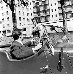 Romance. A young man picks his date up in his car. August 1953 D5205-005 Romance. A young man picks his date up in his car. August 1953 D5205-005