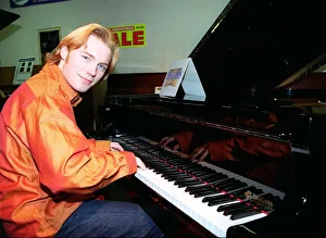 Ronan Keating from boy band Boyzone buys a baby Grand Piano from Biggars music shop in Ronan Keating from boy band Boyzone buys a baby Grand Piano from Biggars music shop in