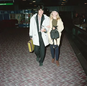 Ronnie Wood and his wife Jo at Heathrow Airport. 28th February 1991 Ronnie Wood and his wife Jo at Heathrow Airport. 28th February 1991