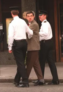 Rowan Atkinson Actor as Mr Bean filming at Harrods - being arrested by policemen Rowan Atkinson Actor as Mr Bean filming at Harrods - being arrested by policemen