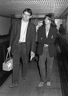 Rowan Atkinson leaving Heathrow Airport with girl. July 1992 P016999 Rowan Atkinson leaving Heathrow Airport with girl. July 1992 P016999