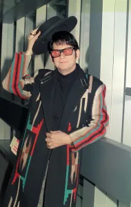 Roy Orbison at Heathrow Airport November 1988 in multi coloured coat holding Roy Orbison at Heathrow Airport November 1988 in multi coloured coat holding