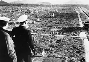 A Royal Navy officer and rating looking across the centre of damage at Hiroshima several A Royal Navy officer and rating looking across the centre of damage at Hiroshima several