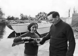 Sailor Donald Crowhurst celebrates with a glass of champagne after the launching of his Sailor Donald Crowhurst celebrates with a glass of champagne after the launching of his