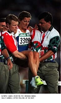 Images Dated 29th July 1996: Sally Gunnell of Great Britain is carried away after collapsing in agony onto the track