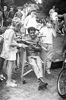 Sammy Davis Junior signing autographs whilst on location of 'One More Time" Sammy Davis Junior signing autographs whilst on location of 'One More Time"