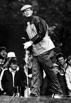 Sandy Lyle golfer watching shot from tee holdng golf club Sandy Lyle golfer watching shot from tee holdng golf club