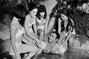 Sean Connery in his roles as James Bond being washed by a group of ladies in a scene Sean Connery in his roles as James Bond being washed by a group of ladies in a scene